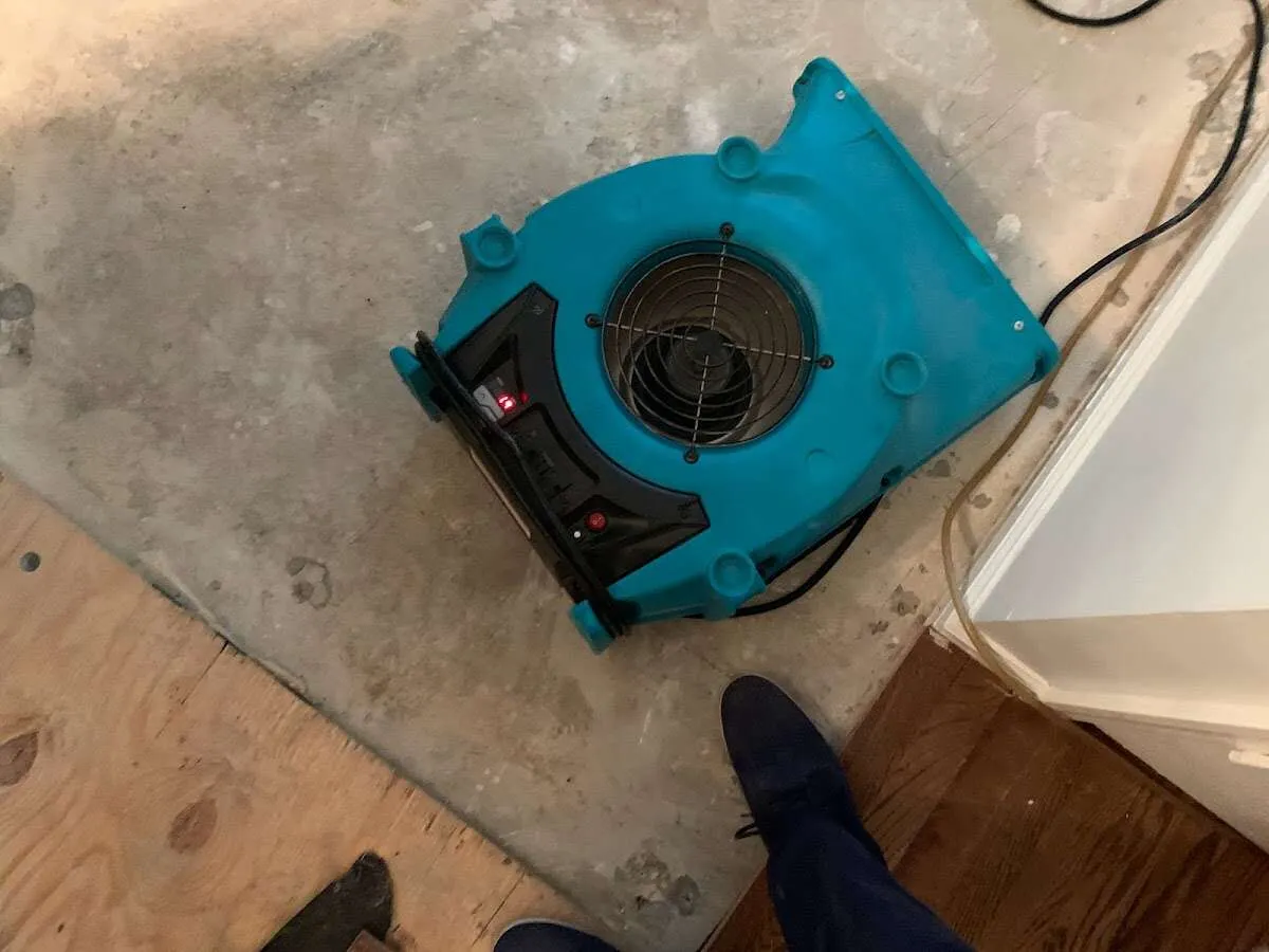 Air mover drying subfloor during Commercial Water Damage Restoration in Foley